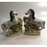 A pair of 19th century Staffordshire figures of Zebra; a pair of 19th century Staffordshire