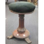 An early Victorian mahogany piano stool with circular padded seat