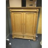 A 20th century pine two door wardrobe with a fitted hanging rail 200 x 151 x 60cm