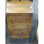 A Regency mahogany cellarette, with domed lid, apron drawer, on square tapering legs with castors (