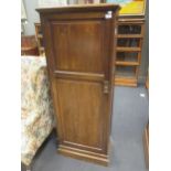 An Edwardian walnut cupboard with shelves enclosed 158 x 61 x 32