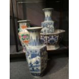 A pair of modern Chinese porcelain vases, of tapering hexagonal form with applied dragons to the
