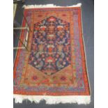 Two floor rugs, a Turkish rug in blue and red 168x105cm; and another with pale ground, 188x125cm (