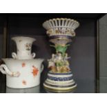 A Dresden type porcelain centrepiece in the form of an open basket, above four figures dancing round