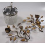 A silver collared cut glass biscuit barrel and a pair of gilt metal candleholders