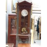 An early 20th century regulation wall clock in an architectural oak case 125cm high