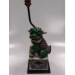 A Chinese famille verte porcelain fo dog figure, late Qing Dynasty, as a lamp stand, the female of