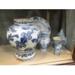 An 18th century Delft charger; a large baluster vase; and three vases; together with lidded jar of
