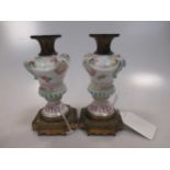 A pair or Meissen porcelain candlesticks with later 19th century gilt brass mounts 11.5cm
