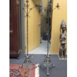 Pair of wrought iron standard lamps on tripod bases
