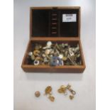 A jewellery box containing a collection of shirt and collar studs
