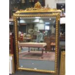 An Italian parcel gilt wall mirror, with twin cherub head cresting, 131x84cm