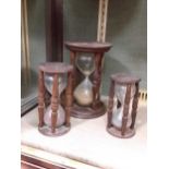 Three hourglasses, late 19th century the longest 24cm high