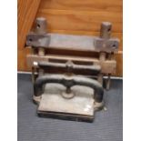 A cast iron book press, and a wooden clamp or press (2)