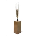 A contemporary steel sculpture of an ear of wheat,