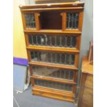 A globe wernicke walnut bookcase, the 5 sections with drawer to base, leaded up and over doors and