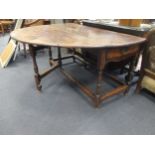 An 18th century oak drop leaf gateleg table with single end drawer 70 x 147 x 169cm open