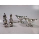 A collection of four silver casters,