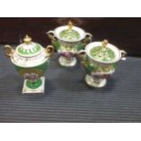 A pair of Regency porcelain two-handled pot pourri and covers, the green ground with central gilt