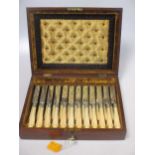 A set of twelve Victorian bone handled fruit knives and forks in a fitted mahogany case.