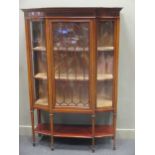 An Edwardian mahogany and crossbanded display cabinet, the central door flanked by shaped glass