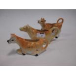 A collection of 20th century cow creamers, a pair of printed vases, 2 Royal Worcester cups,