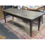 A three plank oak dining table with four tapered and chip carved legs 71 x 196 x 75cm