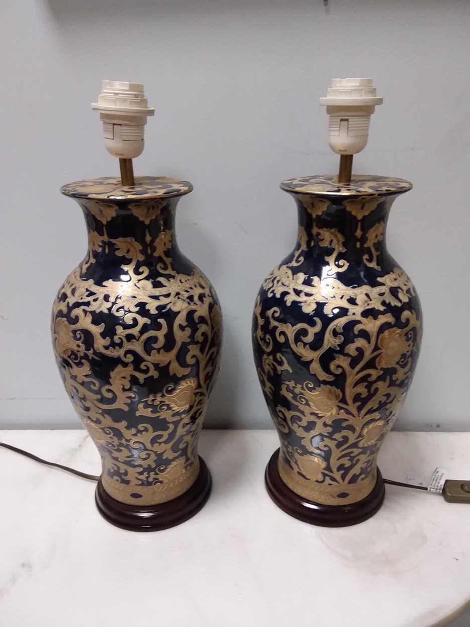 A pair of gilt decorated blue glazed table lamps, 47cm high