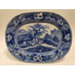 A 19th century blue and white meat plate, printed with a courting couple in a landscape, 55cm