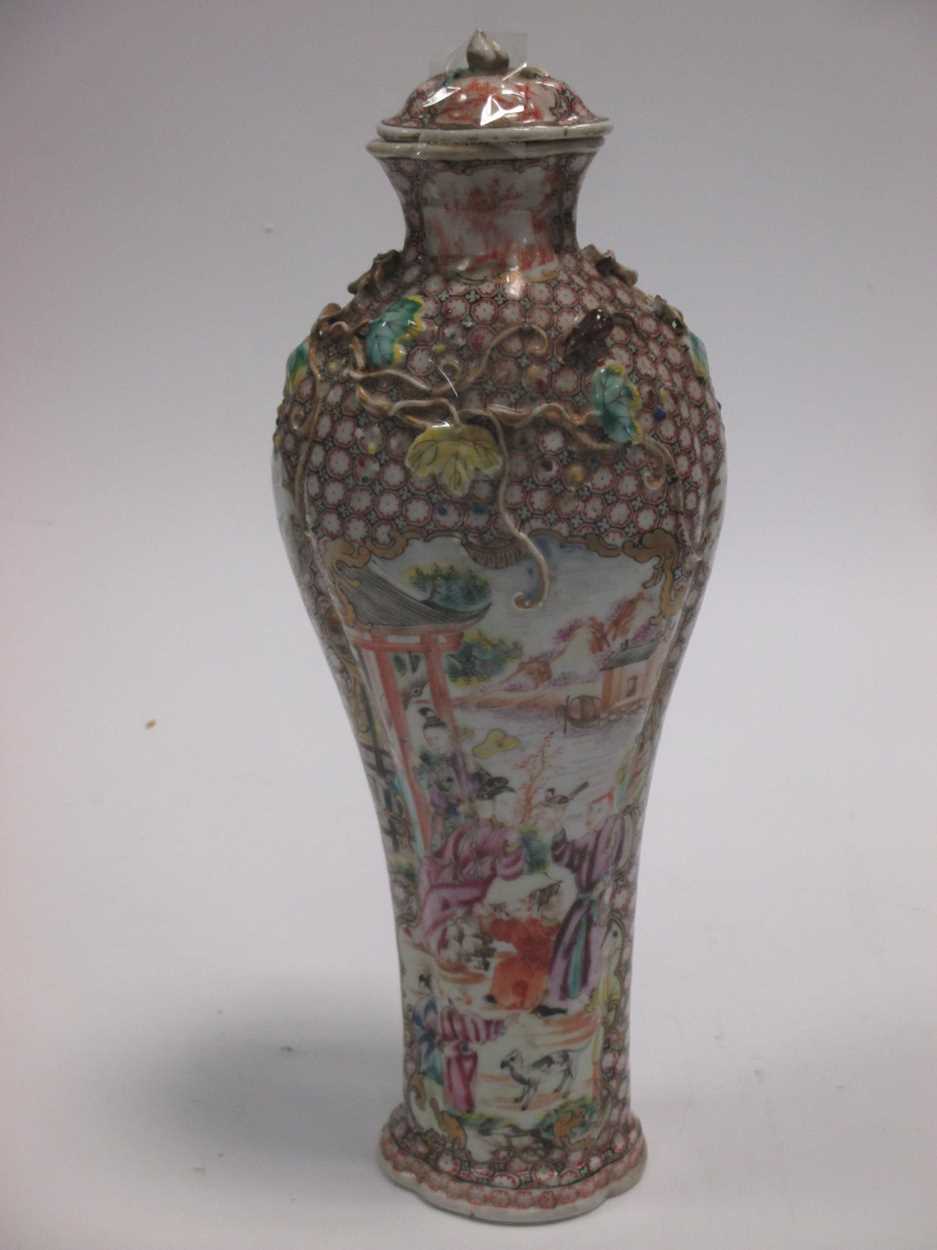 A 19th century Chinese porcelain vase and cover decorated with figures and animals in a garden