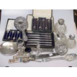 A small collection of silverwares to include cased tea spoons, knives, two dressing table hand