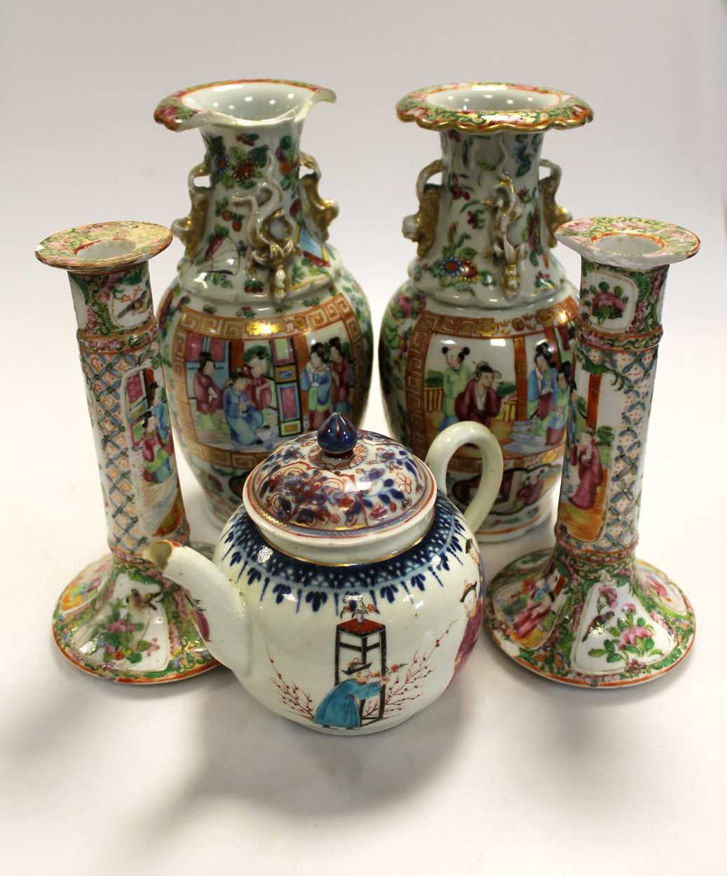 A pair of Cantonese vases and candlesticks; together with a teapot (damages) (5)