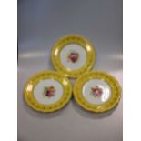 A set of 8 Royal Worcester plates, decorated with central spray of flowers (signed) and yellow