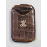 An early 20th century crocodile leather pocket cigar case,