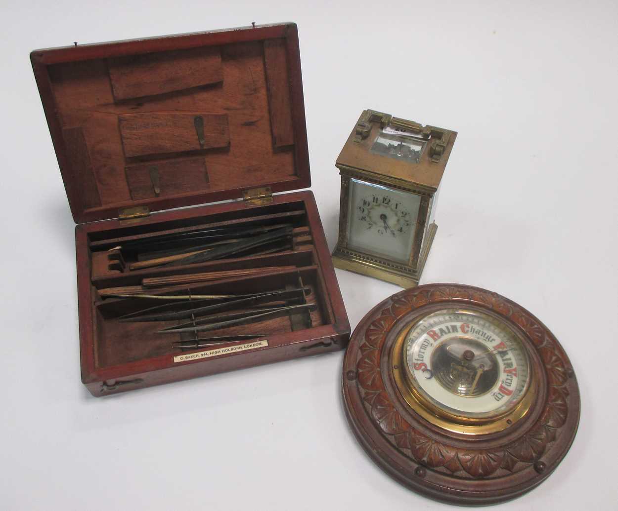 An Edwardian brass carriage clock, aneroid barometer and medical kit