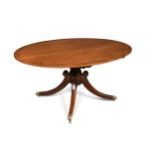 A Regency mahogany oval pedestal dining table, crossbanded border decoration, on four swept legs