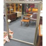 A large silver painted rectangular wall mirror, with bevelled plate, 135 x 105cm