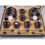 A Royal Doulton coffee service with enamelled spoons, cased