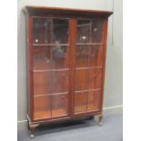 A Victorian mahogany glazed two door bookcase on later cabriole legs, 183 x 126 x 36cm