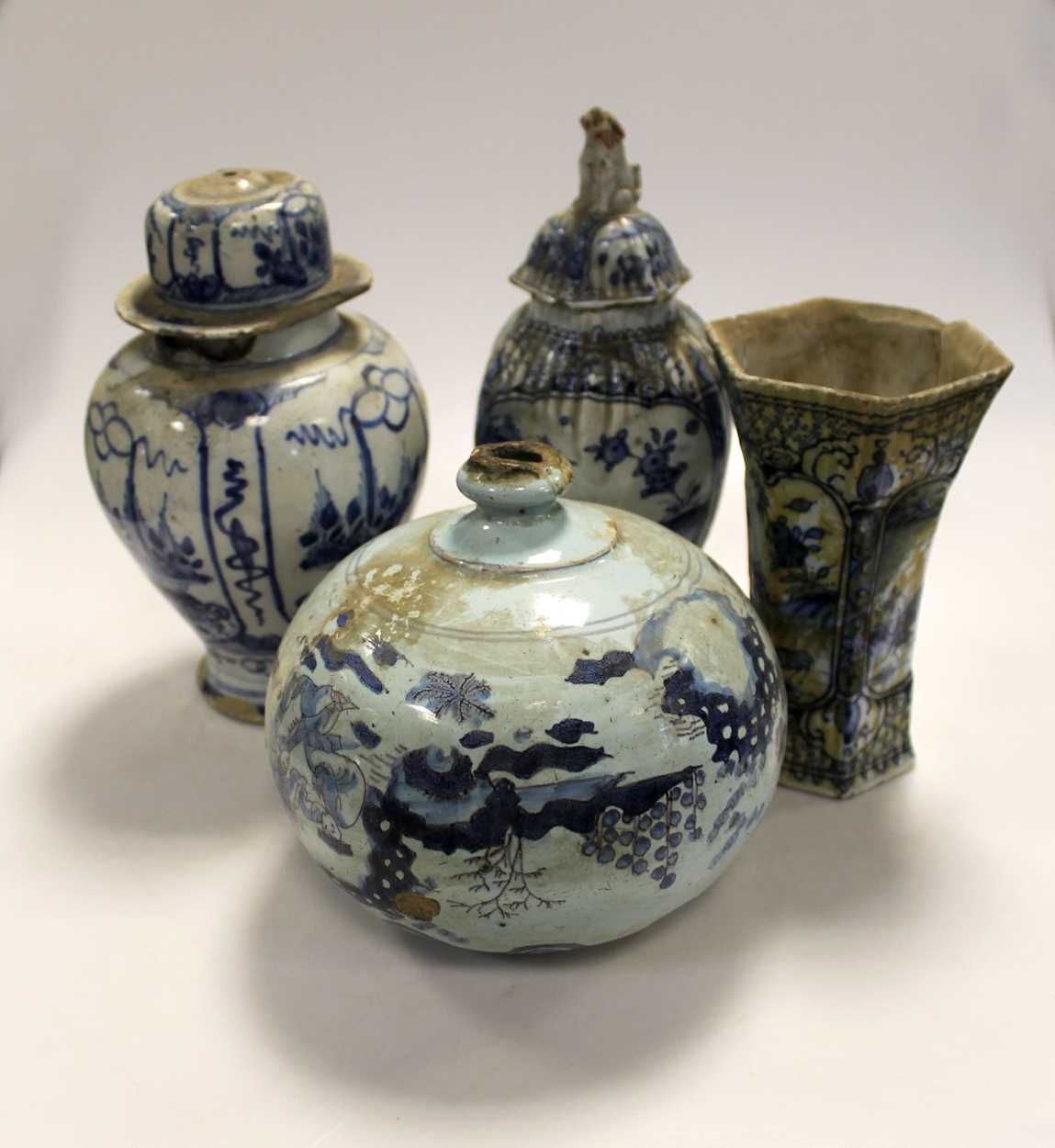 An 18th century Delft charger; three vases; together with lidded jar of squat form, all with