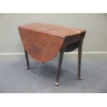 A mahogany oval padfoot drop flap table