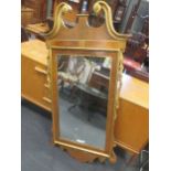 A 20th century William Kent style mirror in walnut and giltwood, 140 x 71cm