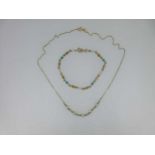 Two hallmarked gold and cultured pearl pieces - a necklace and bracelet,