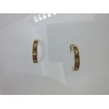 A pair of 18ct gold diamond and ruby earstuds,