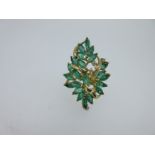 A modern abstract emerald and diamond ring,