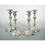 A set of four silver plated on copper candlesticks,