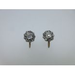 A pair of diamond cluster screw back earrings,