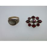 A Georgian mourning ring and a Georgian garnet lace pin,