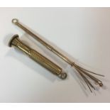 A 9ct gold swizzle stick and a 9ct gold cigar piercer,