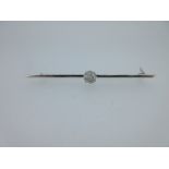 A single stone diamond bar brooch,